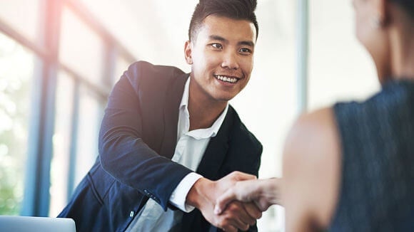 woman smiling in office looking at salary report woman smiling in office looking at salary report