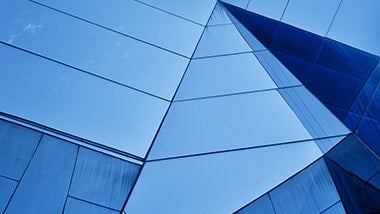 blue building with glass mirrored angular walls