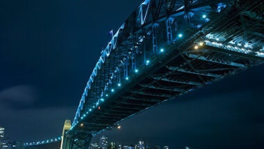 Blue neon lights on city bridge