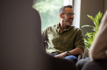 Mature businessman laughing during a meeting with office colleag